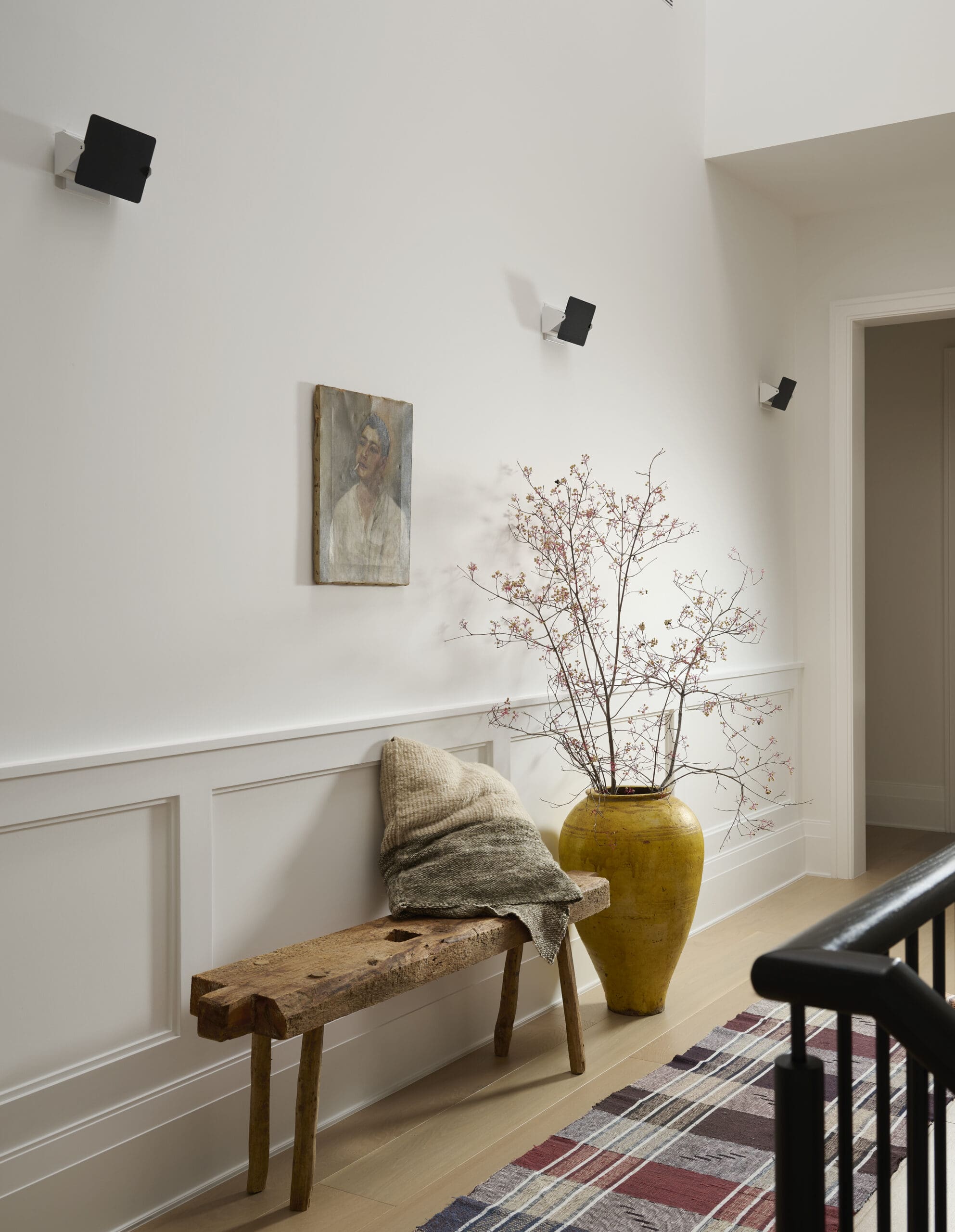 White entryway with bench