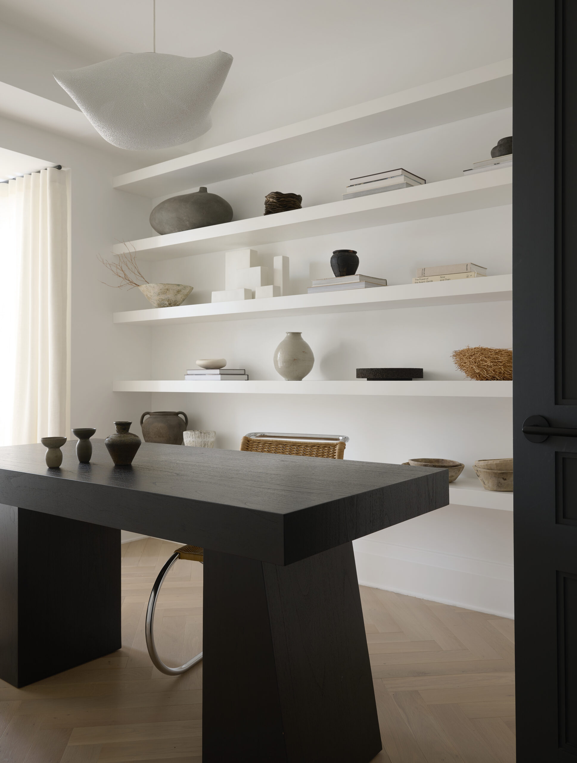 Black desk with white bookshelves
