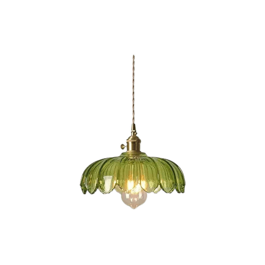 Green glass pendant lamp with brass fixture hanging from a cord, illuminated bulb visible beneath the shade