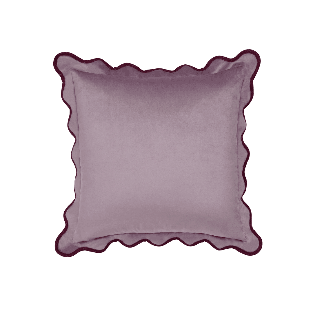 Decorative velvet square pillow in light plum with dark scalloped trim outlining the edges