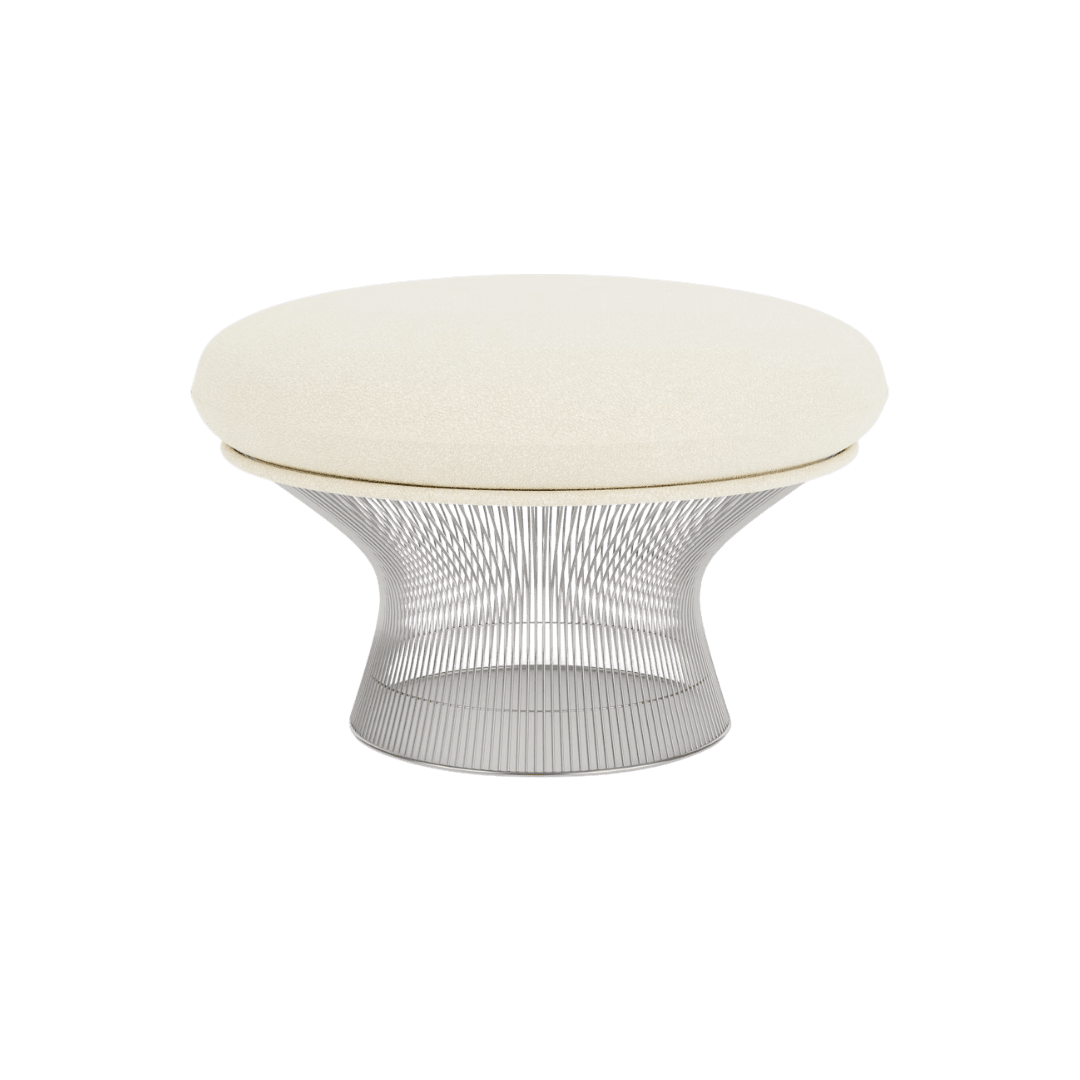 Cream rounded cushion on a sculpted metal wire base ottoman for a modern seating scene.