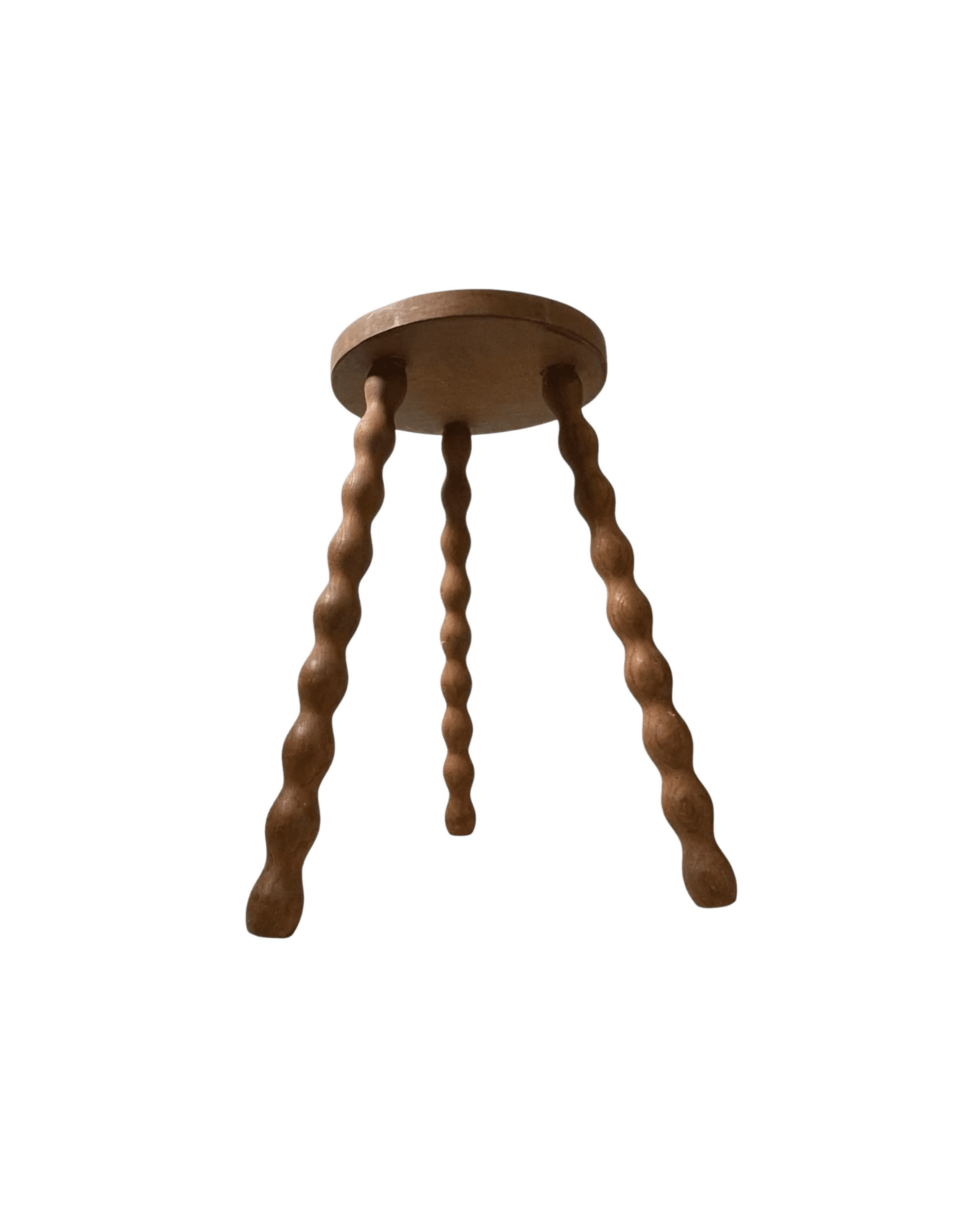 Wooden round-seat stool with twisted, spindle legs extending downward against a black background.