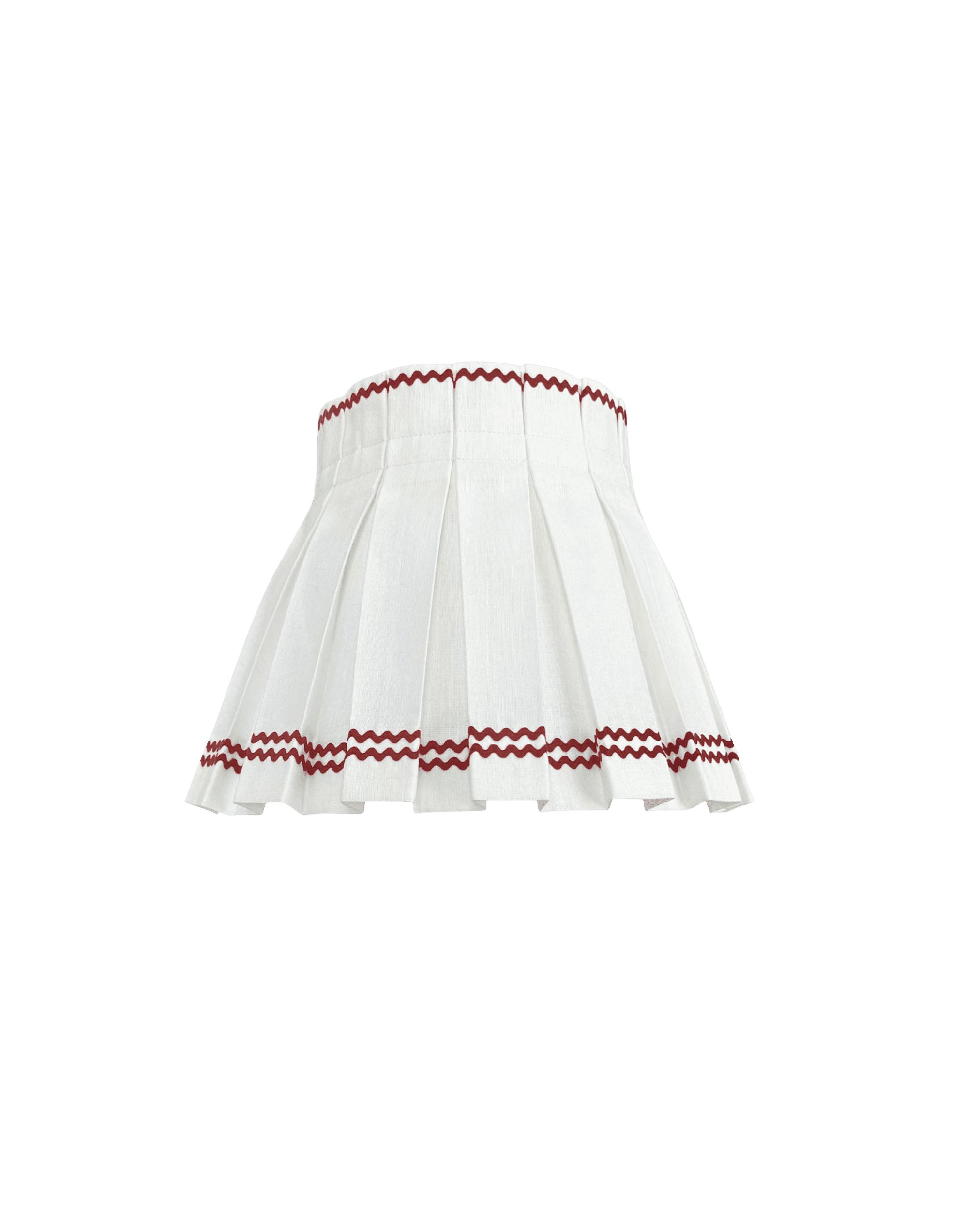 White pleated lampshade with a red zigzag trim, set against a black background (focus on decorative edge).