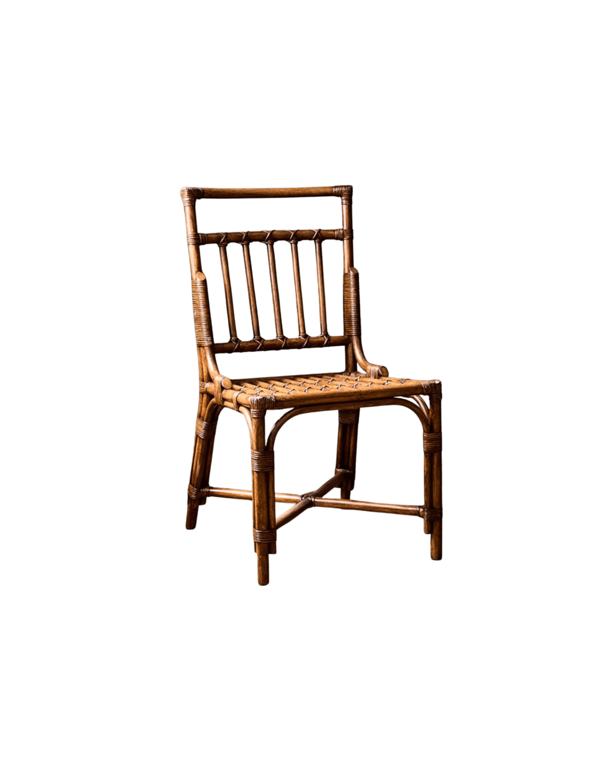 Partial view of a brown wicker chair against a solid black background, showing the back and seat with woven rattan pattern.