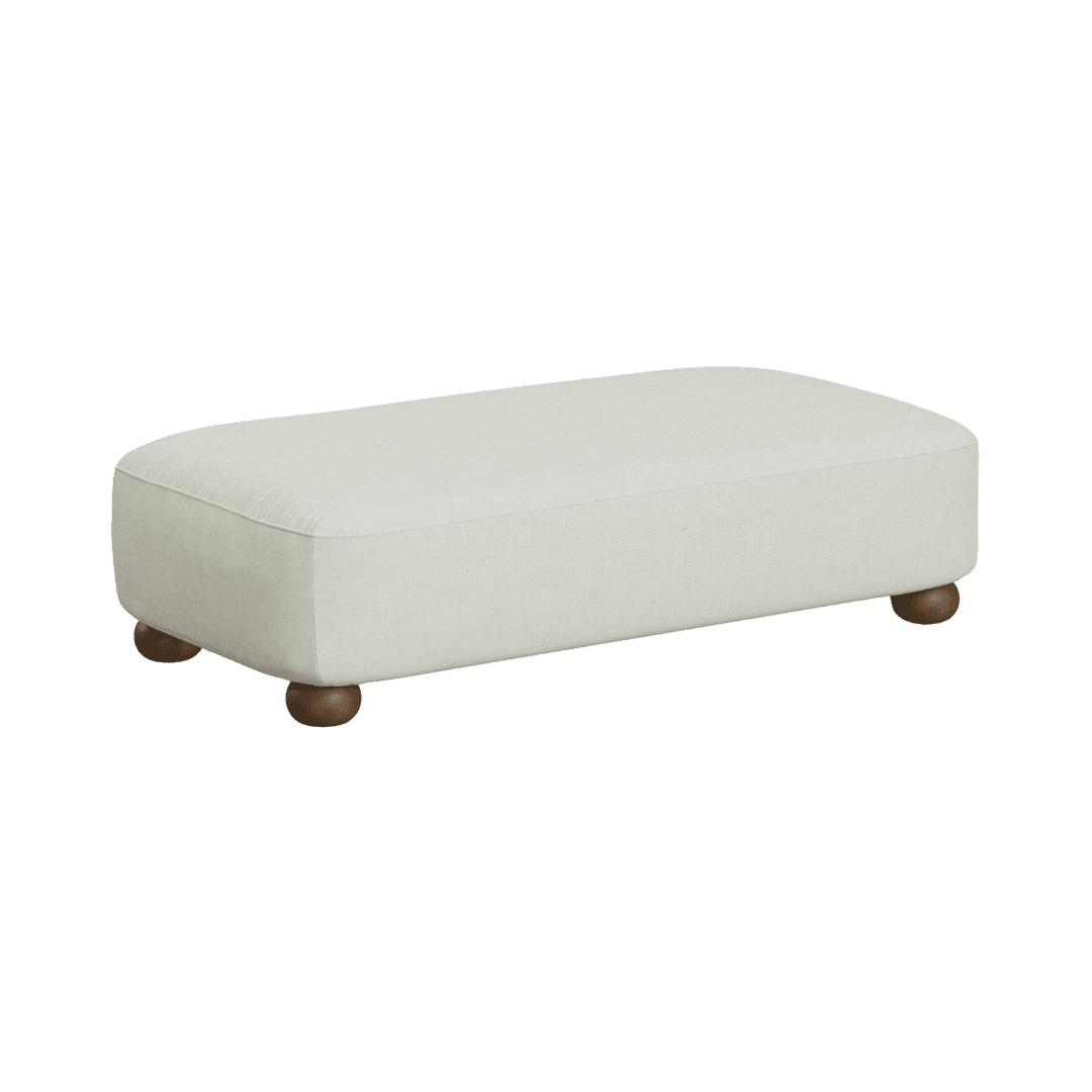 Beige upholstered ottoman with rounded wooden feet on a short leg stance