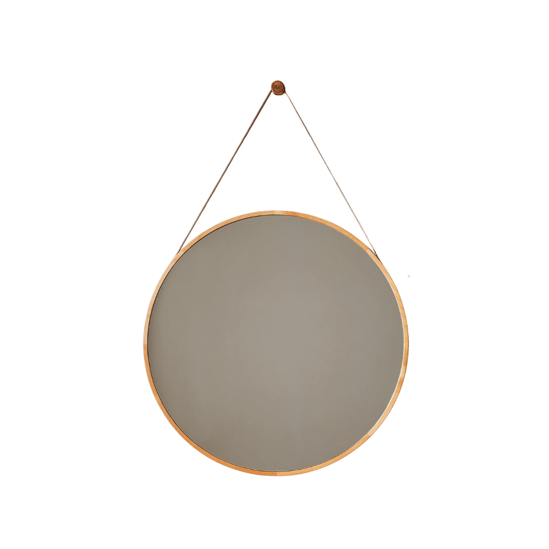 Circular wall mirror with a thin copper frame suspended by two straps.