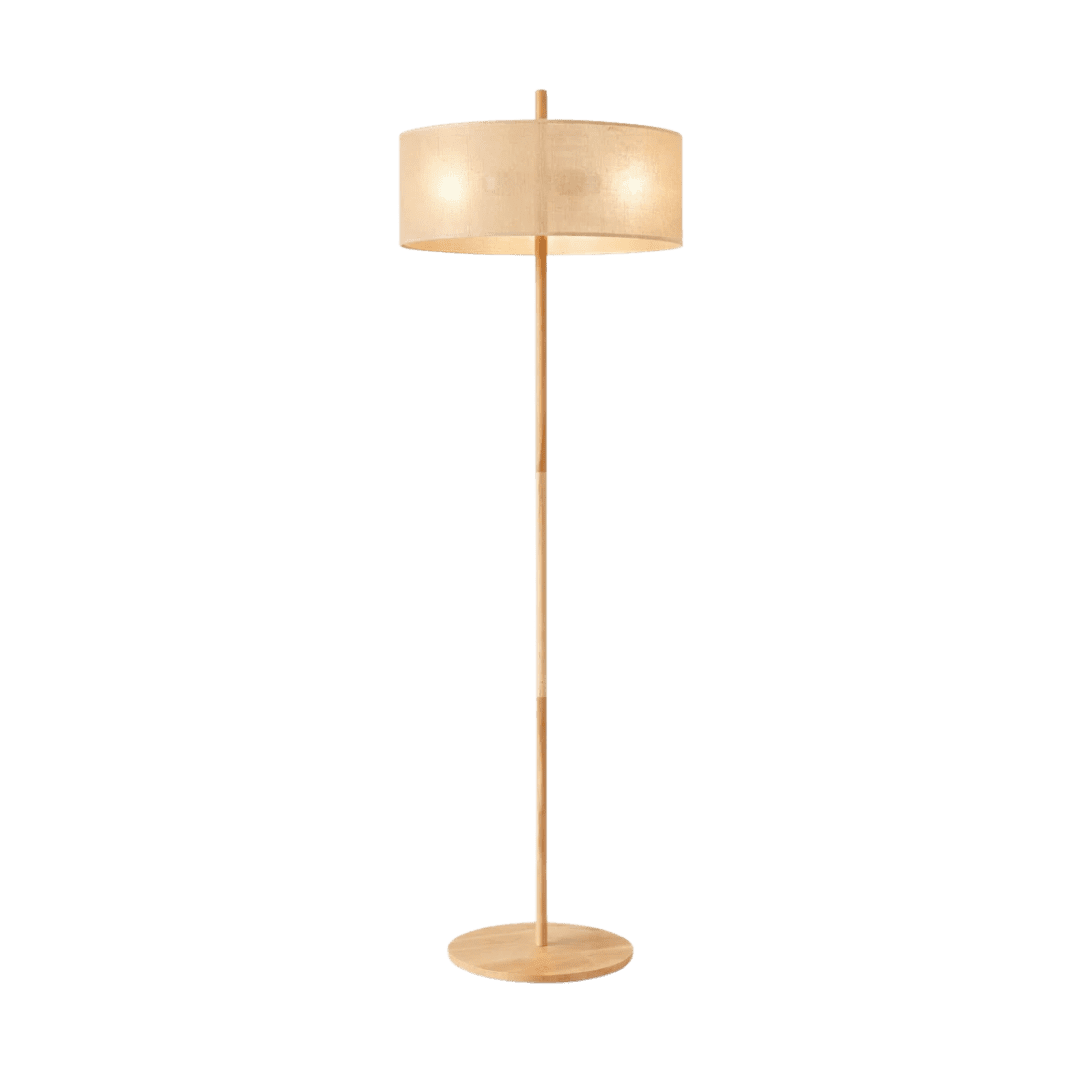 Tall wooden floor lamp with a round base and beige fabric drum shade, emits warm light