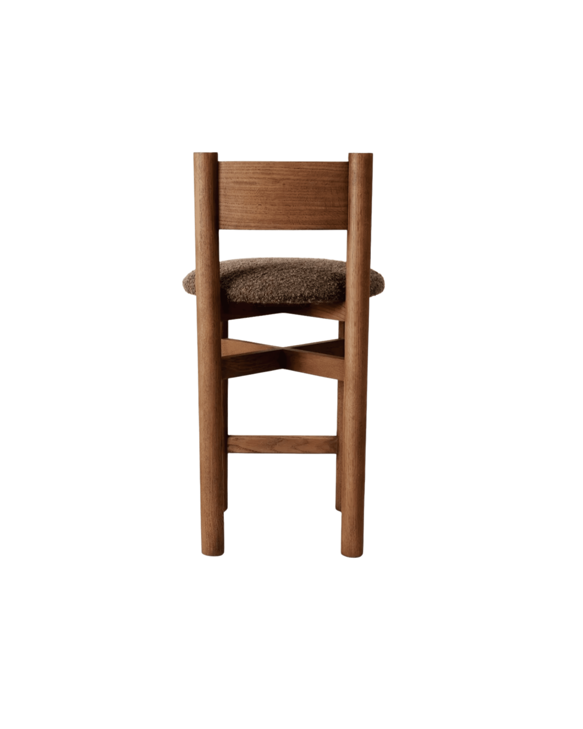 Back view of a tall wooden chair with a brown cushioned seat against a black background