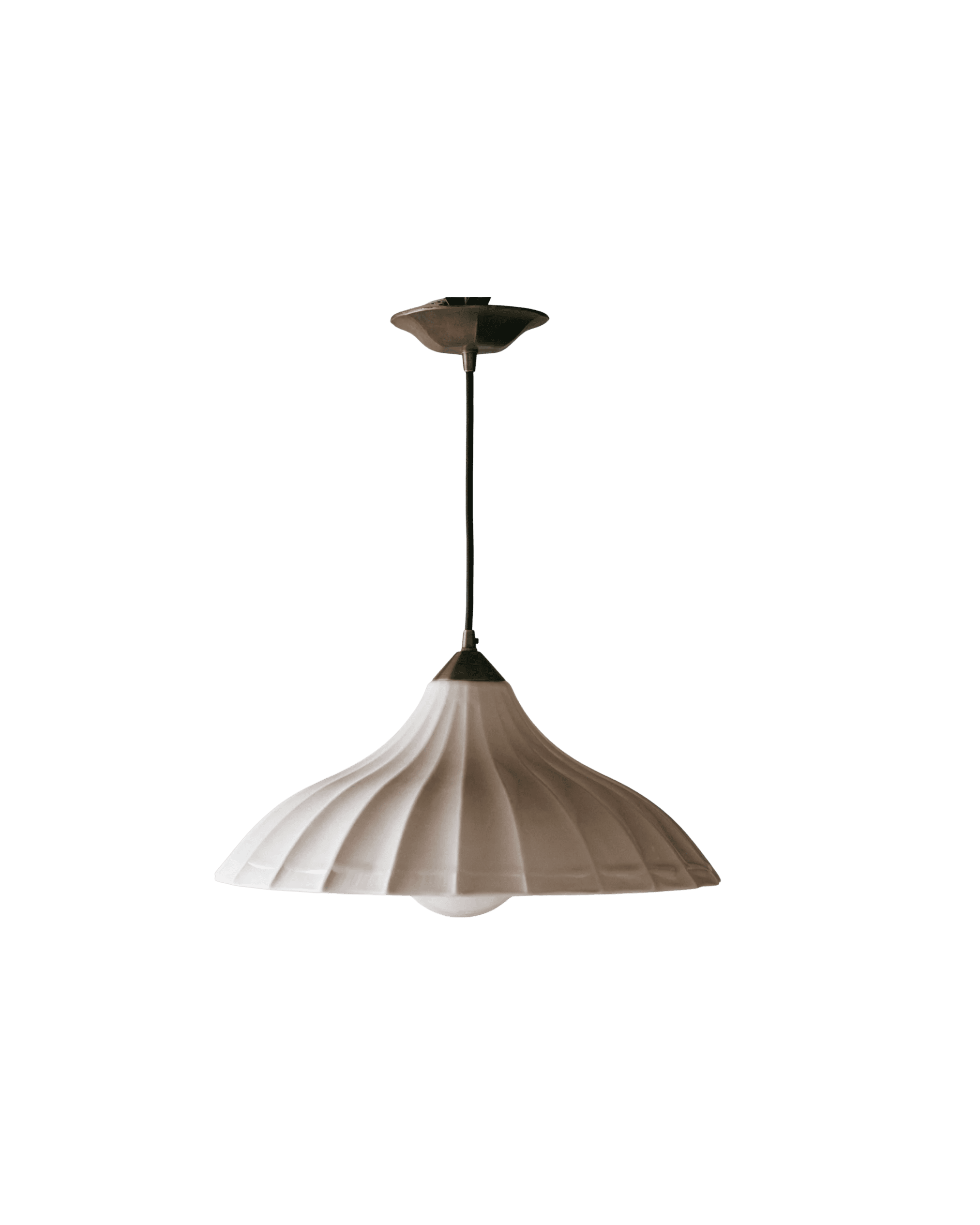 Beige pleated pendant lamp hanging from a dark fixture against a black background.