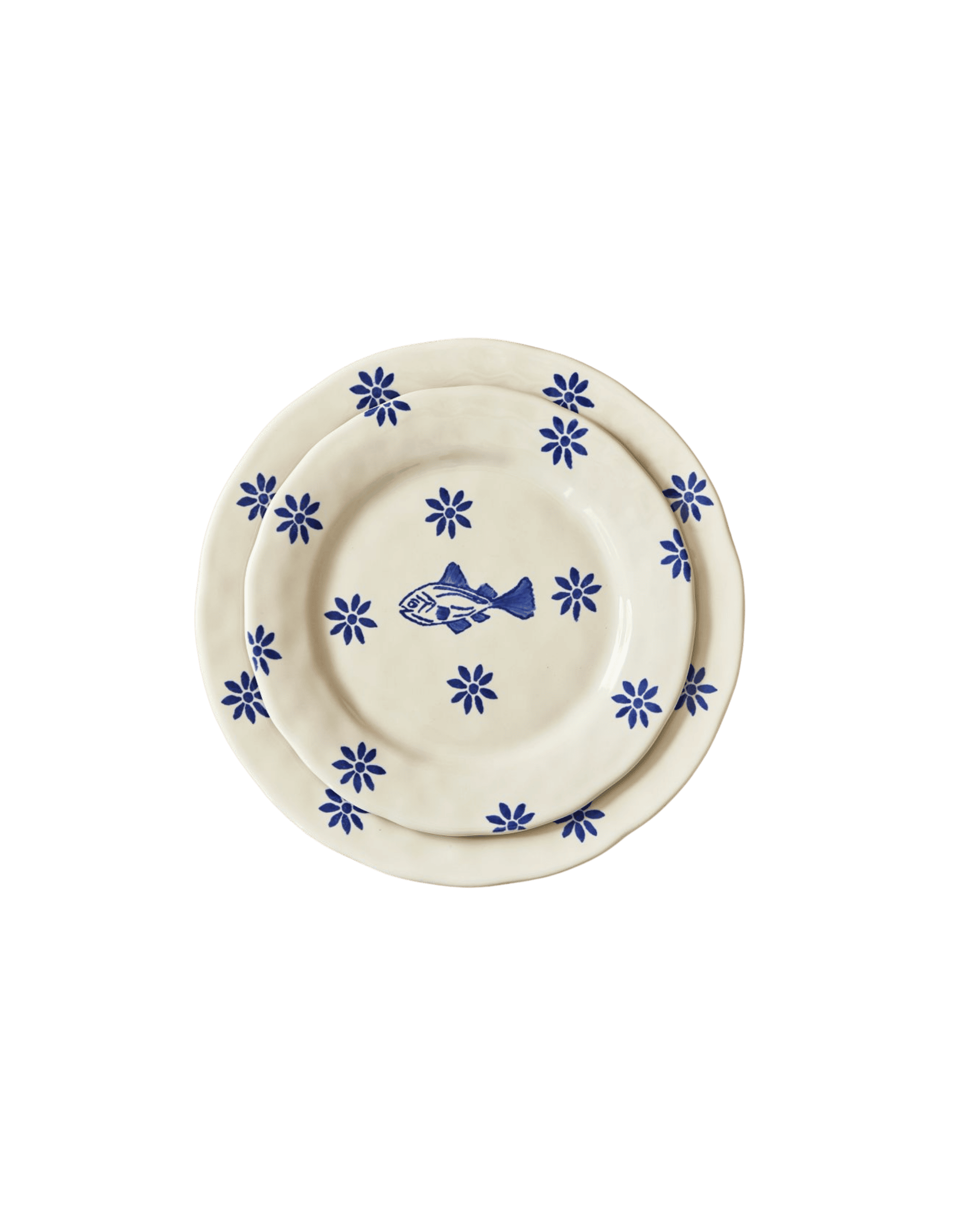 Stack of cream-colored ceramic plates with blue floral border patterns and a central blue fish motif.