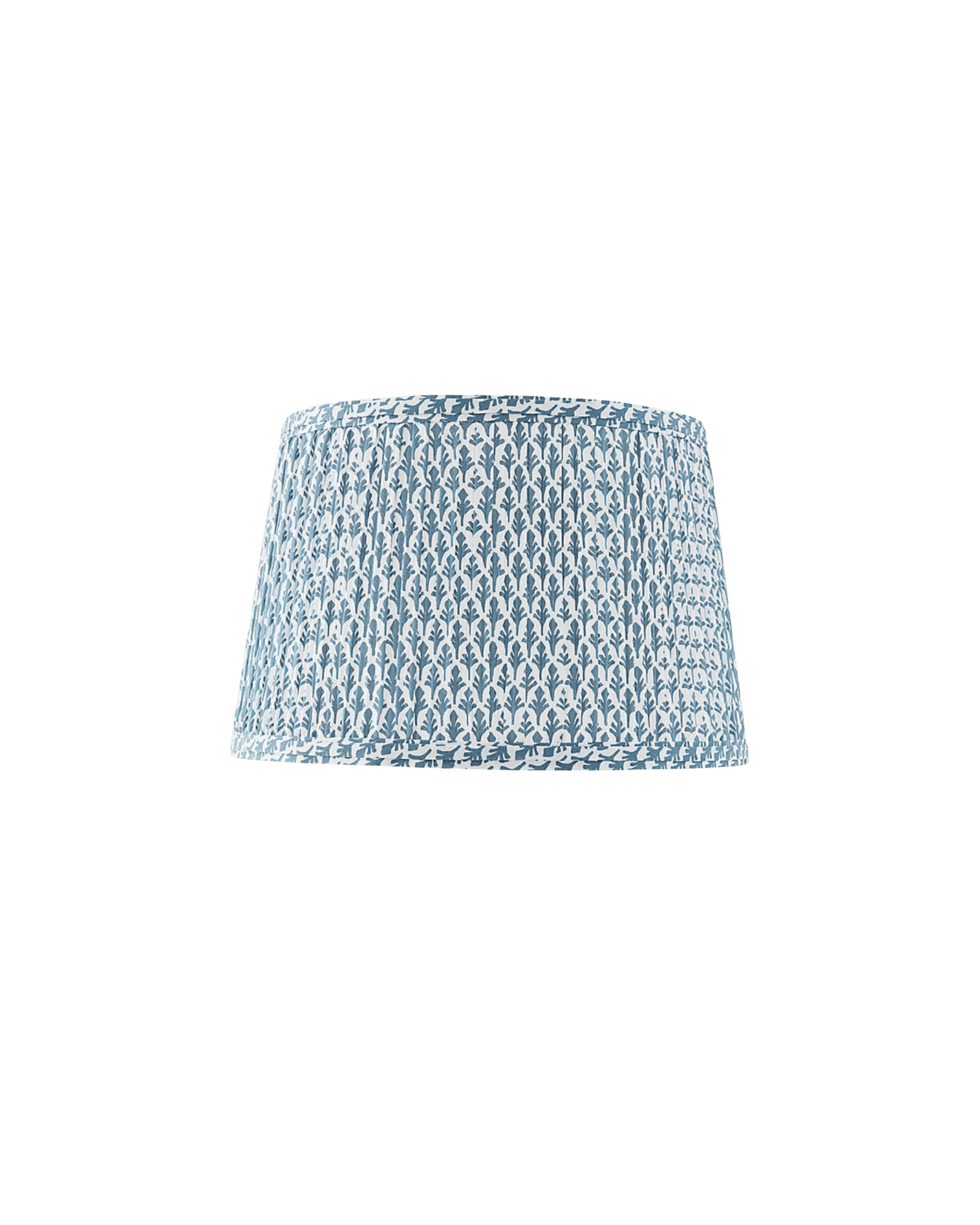 Close-up of a round lampshade with blue botanical pattern on white fabric against a black background, viewed from below.