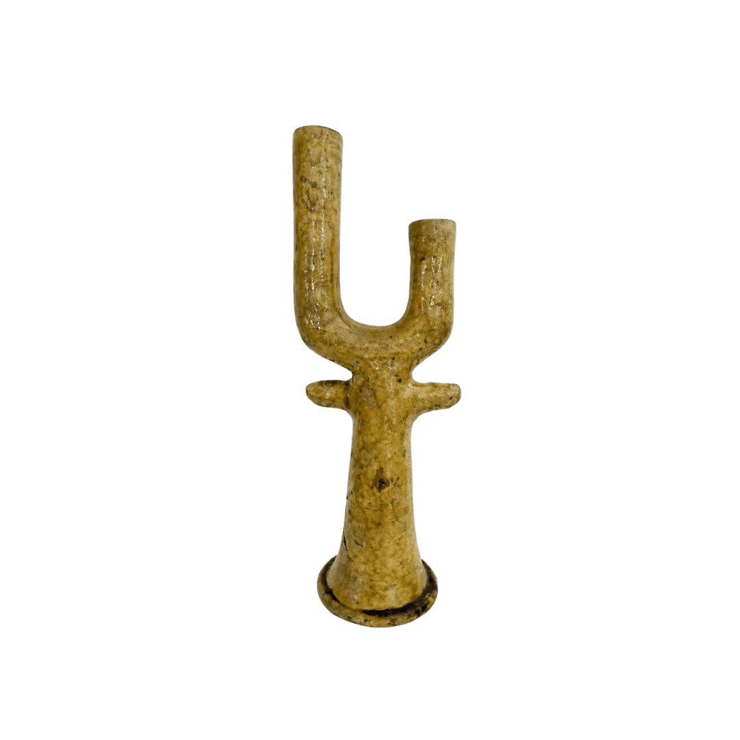 Gold-colored Y-shaped metal object with a circular base, standing upright.
