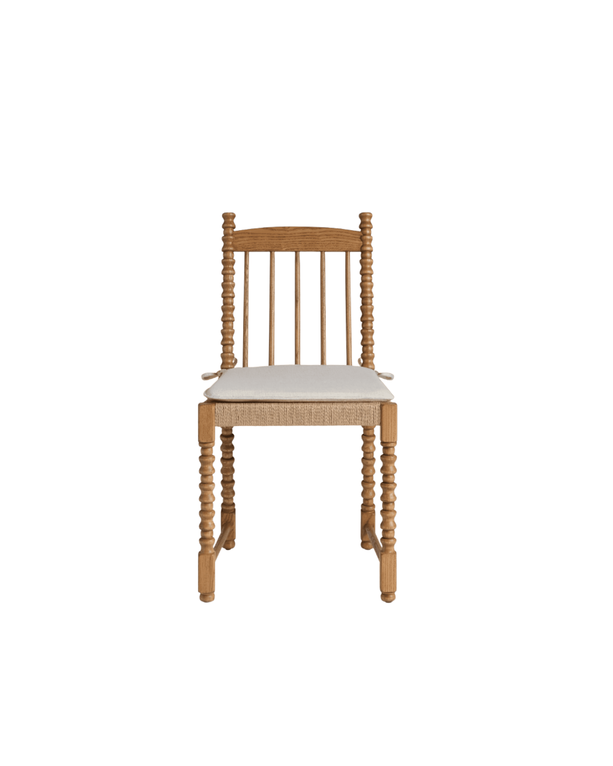 Wooden dining chair with carved spindle legs and backrest against a black background, seat cushion visible at bottom edge.