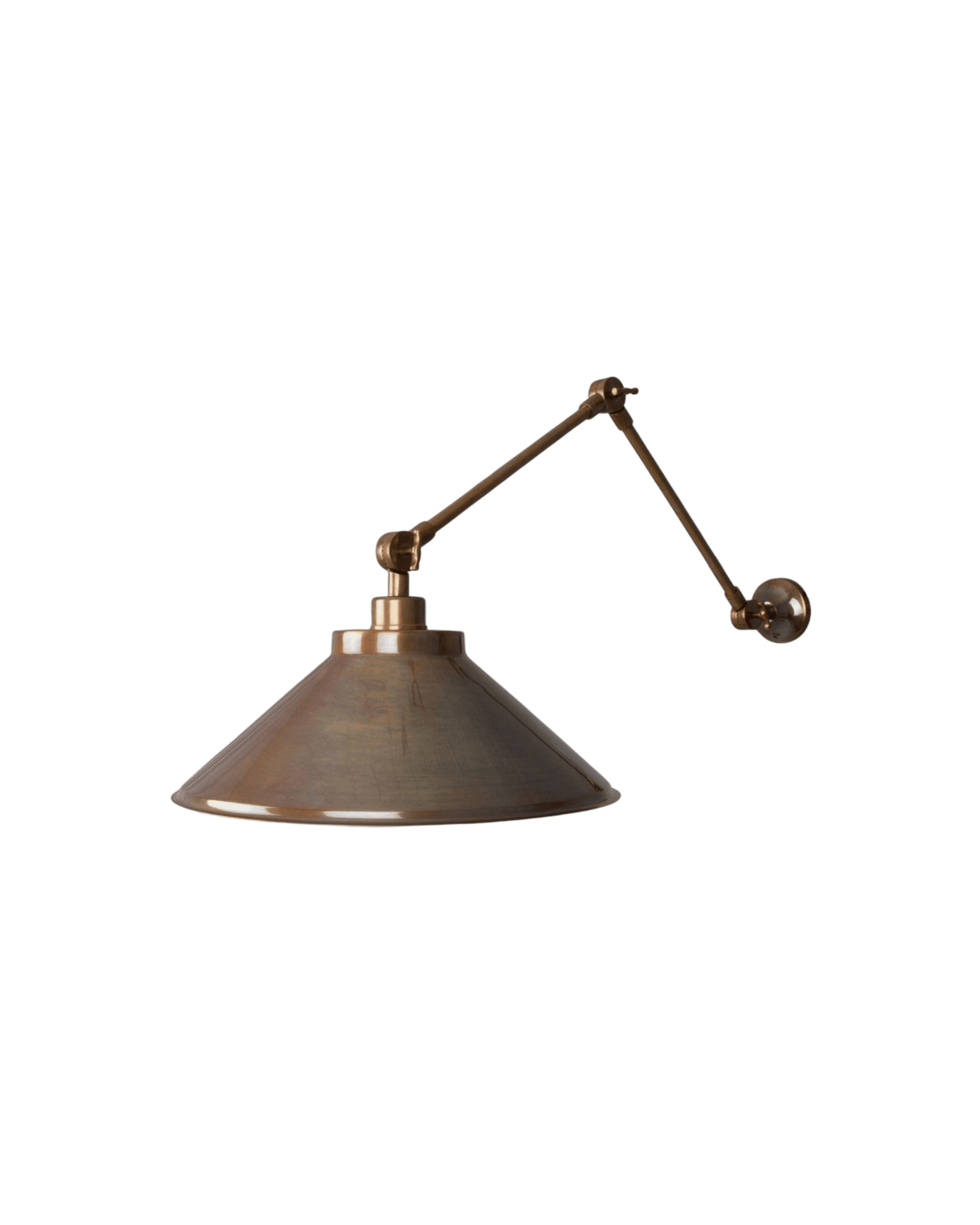 Copper-toned industrial desk lamp with adjustable arms, shown close-up against a black background.