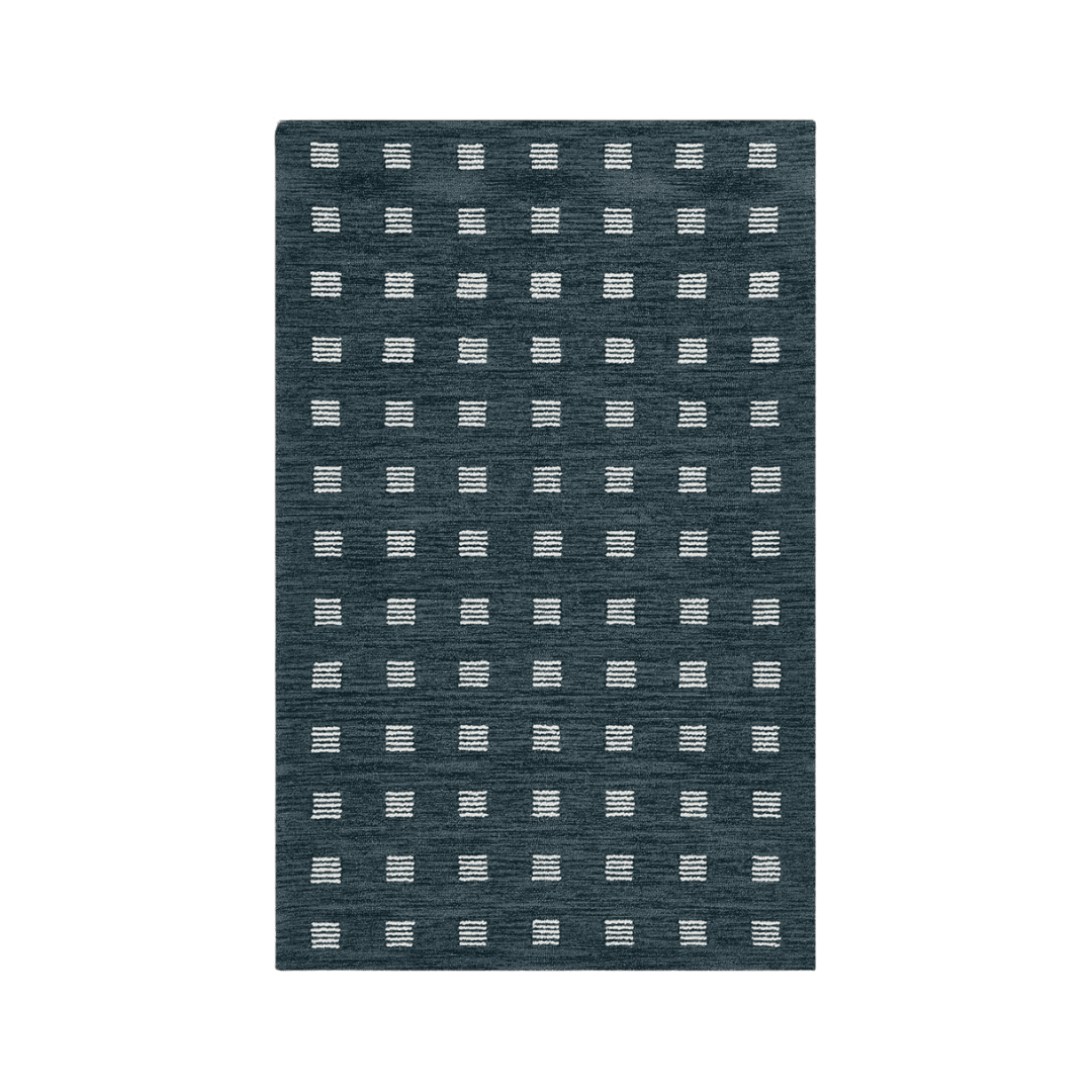 Rectangular dark blue rug with a repeating grid of small white stitched squares.