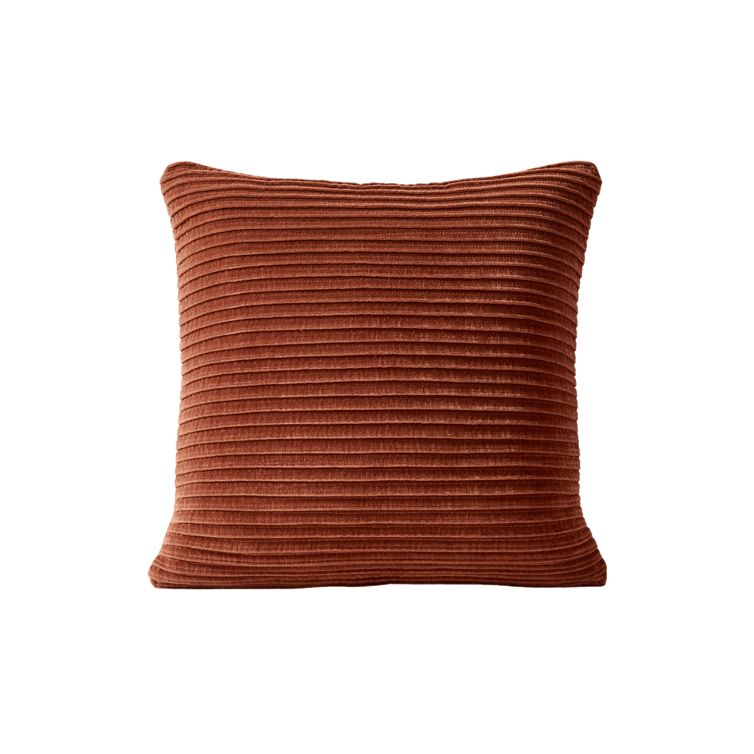 Rust-colored corduroy throw pillow with horizontal ridges